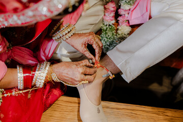 Ceremonial tying of a thread on a groom's ankle. A meaningful tradition symbolizes blessings and...