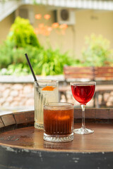 Clear fresh cocktail in a glass on the street on a sunny day