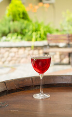 Clear fresh cocktail in a glass on the street on a sunny day
