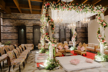 Opulent wedding scene features floral arrangements, chandeliers, and elegant seating for a romantic...