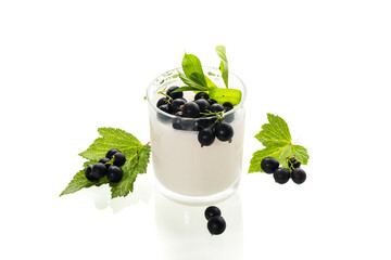 Sweet homemade milk dessert with black currant on white background