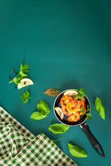 Hot shrimp with citrus slices and spices in a pan