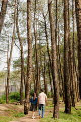 Couple Walking Through Tall Trees