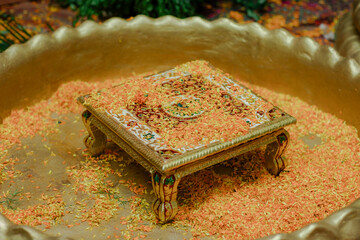 Ornate Wedding Altar: Golden square altar, flower petals, and ceremonial tray set the stage for...