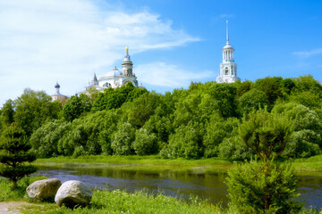 A beautiful view of the Clement Church and the domes of the Borisoglebsky Monastery across the Tvertsa River. Summer landscape of the city of Torzhok.
