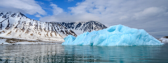 An iceberg floats in the Svalbard archipelago
