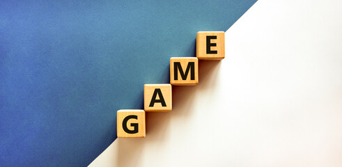 Game symbol. Concept word Game on beautiful wooden blocks. Beautiful white and blue background. Business, lifestyle and game concept. Copy space.