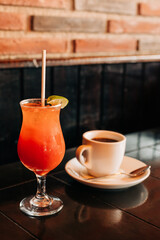 Colorful cocktail and coffee served in an inviting cafe setting during the afternoon