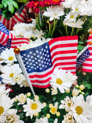 American flags surrounded by chrysanthemum flowers inside a 4th of July-themed bouquet.