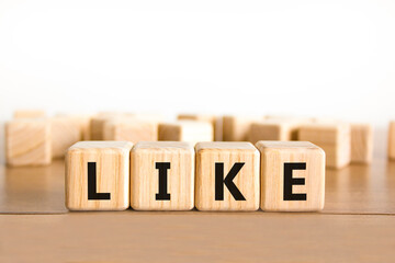 Like symbol. Concept word Like on beautiful wooden blocks. Beautiful wooden table white background. Business, lifestyle, support and like concept. Copy space.