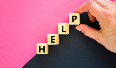 Help symbol. Concept word Help on beautiful wooden blocks. Businessman hand. Beautiful black and purple background. Business, lifestyle, support and help concept. Copy space.