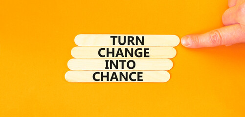 Turn change into chance symbol. Concept words phrase Turn change into chance on beautiful wooden stick. Beautiful orange paper background. Business Turn change into chance concept. Copy space.