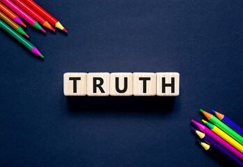 Truth symbol. Concept word Truth on beautiful wooden blocks. Beautiful black table black background. Beautiful colored pencils. Business lifestyle truth concept. Copy space.