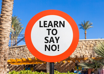 Learn to say no symbol. Concept words phrase Learn to say no on beautiful road sign. Beautiful palm tree and blue sky background. Business psychological Learn to say no concept. Copy space.
