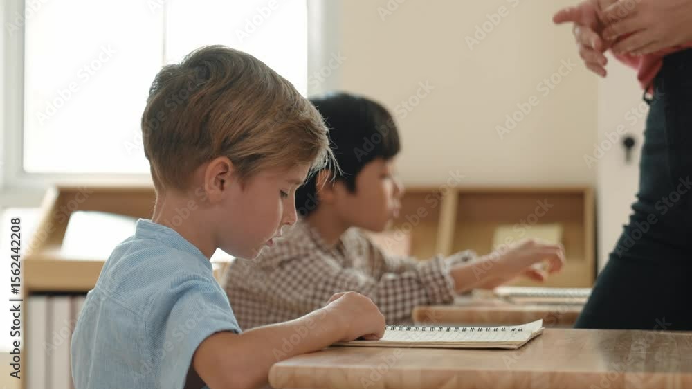 Poster side view of caucasian elementary student looking a note and answer question while sitting in front 