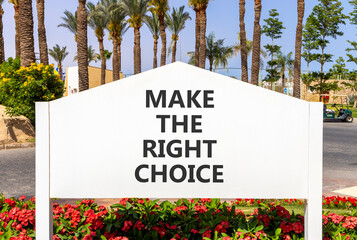 Make the right choice symbol. Concept words phrase Make the right choice on beautiful big white road sign. Beautiful palm tree blue sky background. Business Make the right choice concept. Copy space.