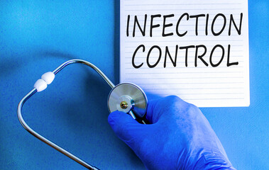 Infection control symbol. Concept words Infection control on beautiful white note. Doctor's hand in blue medical glove. Beautiful blue background. Medical healthy lifestyle infection control concept.