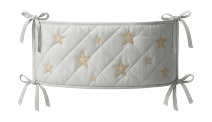 Crib bumper with ties and embroidered stars for a whimsical touch in a baby's crib.