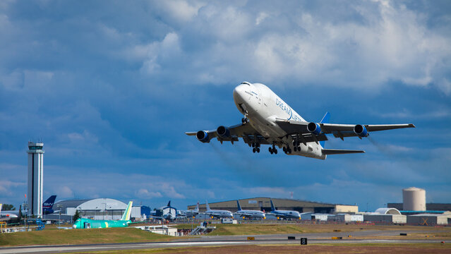 Boeing 747 dreamlifter taking off from paine field airport with blue sky and clouds, July 3, 2014