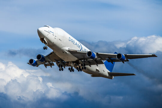 Boeing 747 dreamlifter taking off over cloudy sky