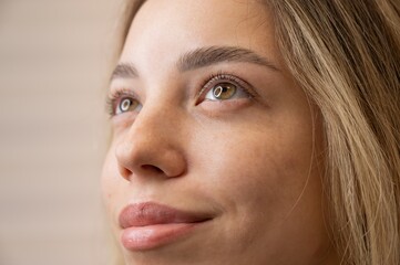 Close-up portrait of a woman after eyelash lamination procedure. 