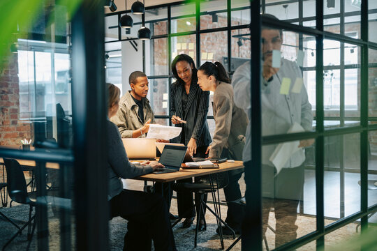 Busy corporate team planning strategies in meeting at office