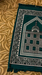 Ornate Green Islamic Prayer Rug on Patterned Carpet