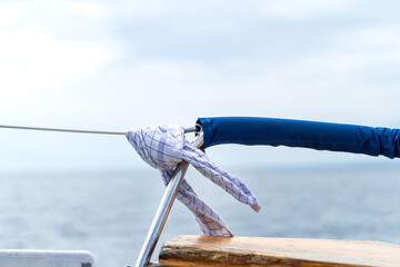 Blue Cloth and Rope Detail on a Sailboat Rail