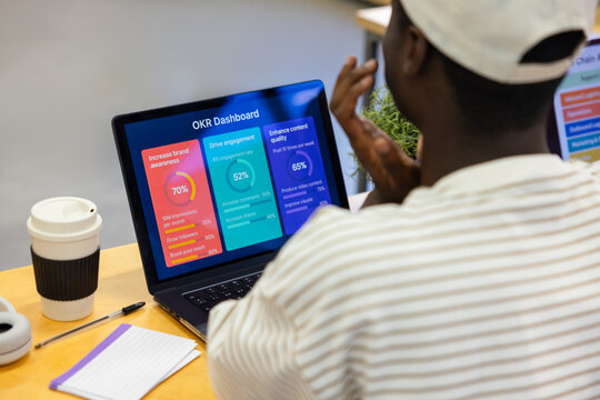 Business professional analyzing data on a laptop