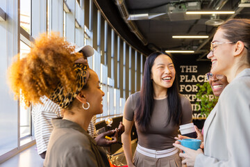 Colleagues enjoying a lively conversation at the office