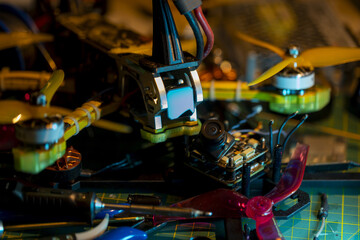 Colorful close-up of components in assembly of 5-inch FPV racing drone on workbench