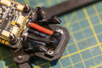 Closeup view of FPV drone circuit board on cutting mat background