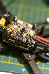 Closeup of 5 inch FPV drone circuit board with wires on workbench