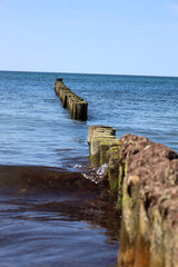 Tranquil waves roll onto the Baltic Sea shore under a wide open sky — a peaceful moment by the...