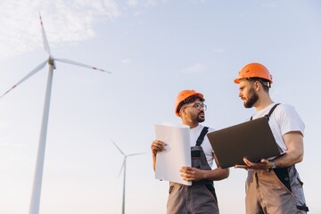 Engineers discussing about a project in a wind turbine power plant