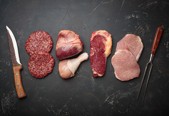 Selection of assorted raw meat cuts for zero carb carnivore diet: uncooked beef steak, pork, ground...
