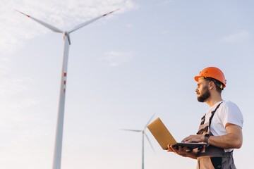 Engineer working with laptop in a wind turbine power plant