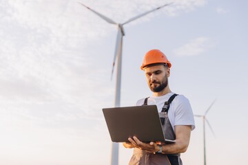 Engineer working with laptop in a wind turbine power plant
