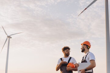 Arabian engineers discussing about wind turbines for sustainable energy production