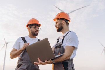 Engineers working on a laptop in a wind turbine power plant