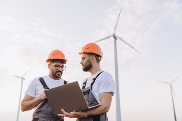 Engineers working on a laptop in a wind turbine power plant