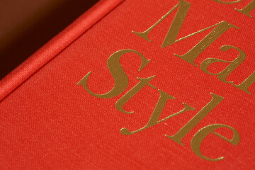 Closed Red Hardcover Book on Brown Surface

