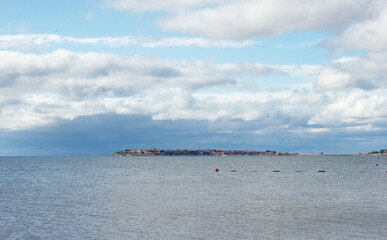 Landscape, amazing view of island of Nessebar in distance, sea and clouds. Beautiful summer holiday at black sea