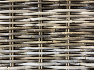 Natural woven texture of bamboo and rattan materials, showcasing intricate patterns and earthy...