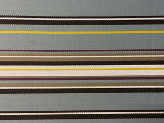 Textured fabric background featuring horizontal stripes in various colors, showcasing natural...