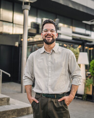 Fototapeta premium Portrait of man with beard and eyeglasses stand in the street