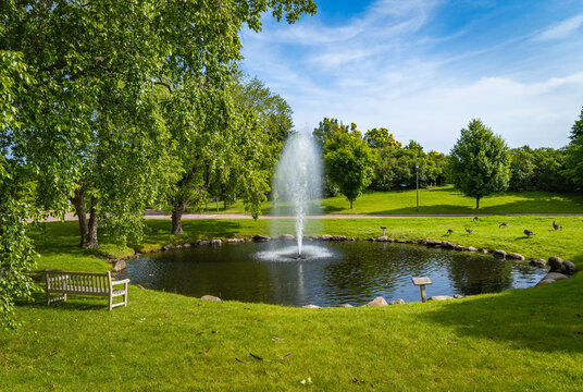 Fountain at the pond in Minnesota Arboretum - Powered by Adobe