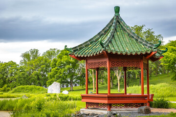 Beautiful chinese garden with red Gazebo on sunny day