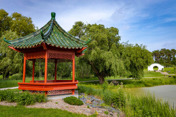 Beautiful chinese garden with red Gazebo on sunny day