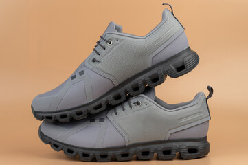 Stylish gray athletic shoes displayed on neutral background for fashion inspiration